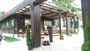 a statue of a chef standing in front of a building at Hotel Evia in Eforie Nord