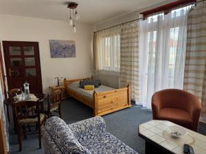 a living room with a bed and a table and chairs at Penzion Trstená in Trstená