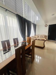 a dining room with a table and a couch at Celestial Negombo Resort Transit Stopover Villa 85 in Negombo +6 photos