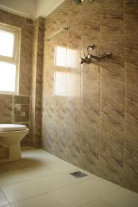a bathroom with a toilet and a shower at Simple & Sustainable- Room with facilities a guest need in Kathmandu +14 photos