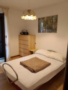 a bedroom with a bed with a rug on it at Piera' s House in Caderzone