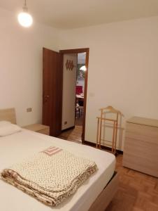 a bedroom with a bed and a door to a room at Piera' s House in Caderzone +16 photos