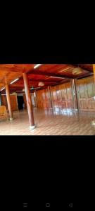 a large room with wooden floors and wooden beams at Homestay trọng hiếu in Na Tong