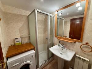 a bathroom with a shower sink and a washing machine at C19 - Bellavista Pirineo - Villmor in Cerler +24 photos