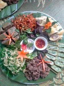 a green plate of food on a table at Homestay trọng hiếu in Na Tong +28 photos