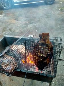 a grill with a piece of meat on it at Homestay trọng hiếu in Na Tong