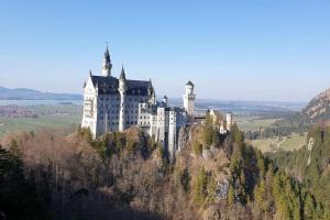 a castle sitting on top of a mountain at Apartment Alpenblick 11, Halblech im Allgäu, Bergblick pur - NEUERÖFFNUNG! in Berghof
