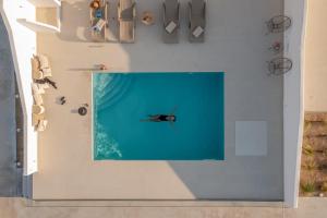 a person is in the water in a room at Eupnoia Villas in Agios Arsenios +119 photos