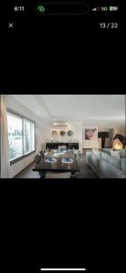 a living room with a couch and a table at RDC Villa avec Jardin & Piscine Privée in El Aouina Station