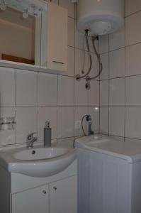 a white bathroom with a sink and a mirror at Apartment Drazan in Šibenik +85 photos