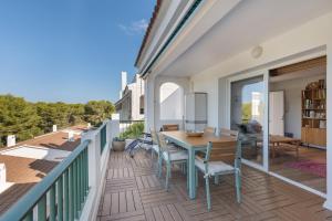 a patio with a table and chairs on a balcony at Casa Golf in Son Parc