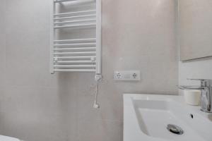 a white bathroom with a sink and a mirror at Casa Golf in Son Parc +25 photos