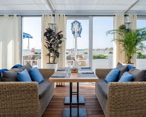 a living room with two couches and a table at Seabreeze Baku Lighthouse seaview apartment studio in Baku