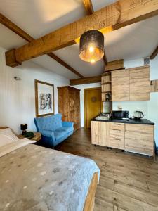 a bedroom with a bed and a blue couch in a room at Apartamenty Butorowy in Kościelisko