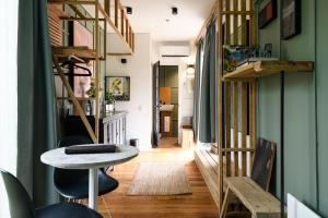 a room with a table and chairs and a hallway at The Retreat - Reconnect with nature in style in Musk