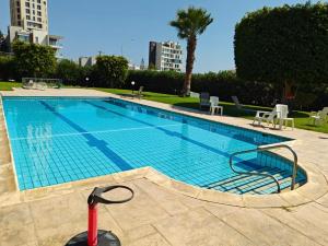 a swimming pool with a red scooter next to it at Brand new sea view walking distance to the sea 200m in Limassol