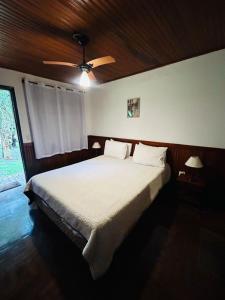 Ένα ή περισσότερα κρεβάτια σε δωμάτιο στο Chalé Tia Sofia 7