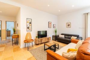 MoulèsMaison en campagne Arlésienne avec piscine的客厅里有一张沙发和一台电视