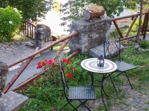 a table and two chairs and a table and flowers at La Stellina in Garda
