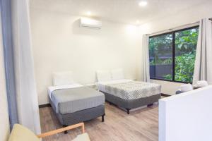 a room with two beds and a window at Somnara Bosque Tropical in Talamanca