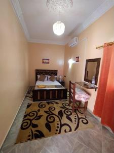 メルズーガにあるSahara Dream Apartmentのベッドとテーブルと鏡のある寝室