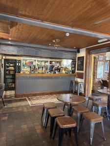 a restaurant with tables and stools and a bar at The Shakespeare Inn Coalport in Coalport