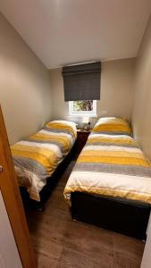 two beds sitting next to each other in a room at Entick Lodge No 4 in Dunswell