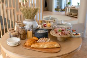 a table with bread and other food on it at SEASENSE Boutique Beach Villa in Wilderness