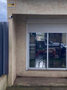 a window of a house with a table and a patio at Zule in Salto
