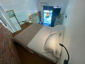 a bedroom with a large bed with a video game at Sophia Loft Luxury Stay with Parking in Athens