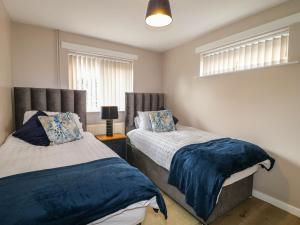 En eller flere senge i et værelse på Wigley Farm House Cottage