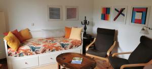 a room with a bed and a chair and a table at Landhaus Lange3 Moderne Kunst in Poitendorf