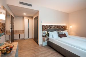 a bedroom with a large bed in a room at Weinhotel Wasem in Ingelheim am Rhein +41 photos
