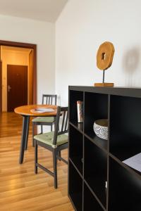 a dining room with a table and a table and chairs at Cozy Corner by Bytko in Nitra