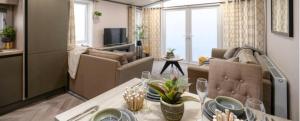 a living room with a dining table and a living room at 7b Oakwood village in Wilberfoss