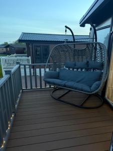 a wicker chair sitting on a deck at 7b Oakwood village in Wilberfoss