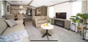 a living room with a couch and a table at 7b Oakwood village in Wilberfoss +3 photos