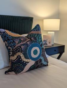 a pillow sitting on top of a bed at Quentin's Cottage in Queenstown