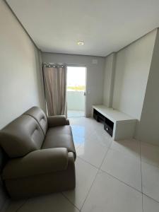 a living room with a couch and a table at Flat shopping Ibituruna in Montes Claros