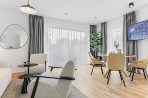 a living room with chairs and a table at cruwzo I Regensburg Towers - Design Apartments in Regensburg