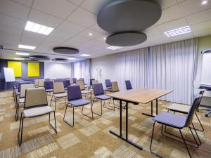 a conference room with a table and chairs at ibis Mulhouse Centre Filature in Mulhouse