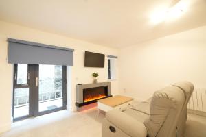 a living room with a couch and a fireplace at The Lodge in Dunmore