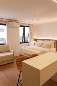 a hotel room with two beds and a couch at BOOK A FLAT Alameda Lorena Jardins in São Paulo +41 photos