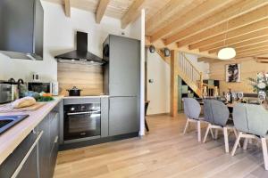 a kitchen and dining room with a table and chairs at Chalet D'ardent - Chalet D'Ardent - 8/10 personnes - Montriond MAE-0493 in Montriond