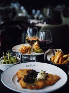 a table with plates of food and glasses of wine at Quality Hotel Arlanda XPO in Arlanda