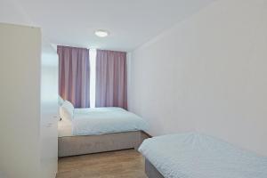 a bedroom with two beds and a window at Spacious family apartment in Bamberg in Bamberg +15 photos