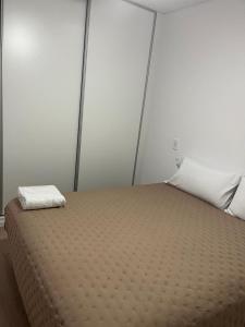 a bedroom with a bed with a pillow on it at Departamento Rodriguez in Bahía Blanca