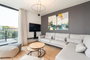 a living room with a couch and a table at Dunique 0302 in Bredene-aan-Zee