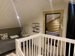 a room with a bed and a staircase in a attic at Villa Marrikka, Levi in Levi