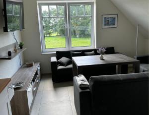 a living room with a couch and a table at Ferienwohnung Linus OG 95172 in Rhauderfehn